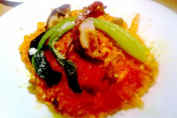 Delicious and colorful risotto with eggplant and grated cheese at Kitchen Kanra