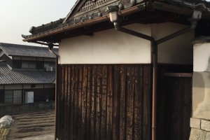 An old structure with scorched cedar panels in Konko-cho