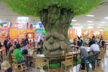 <p>Xystus Kids Land is anchored in its middle by a grand artificial tree surrounded by seating surrounded by the play areas and specialty rooms</p>