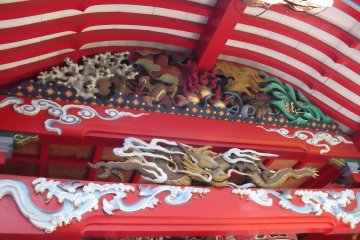 Brightly painted carvings under the eaves of the prayer hall
