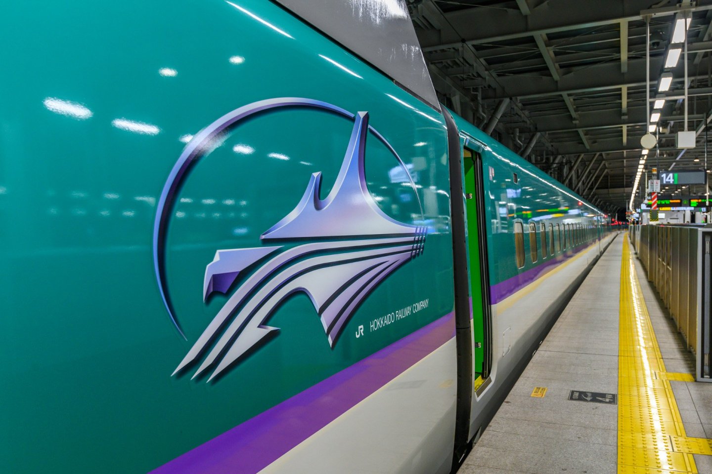 Photo of the Hokkaido Shinkansen with the logo on the side of the train