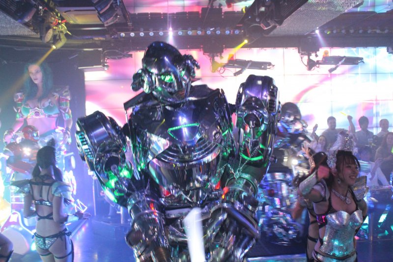 Robots march down the stage and show off their shiny armor.