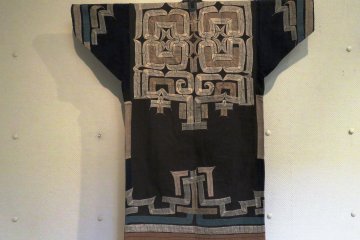 This Ainu robe is known as the Attu, which is made from the fibres of a Japanese elm tree. The Ainu hold these trees in high regard, seeing them as sources of wisdom. 