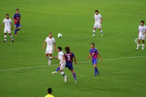 Tokyo's Masato Morishige challenges for the ball.