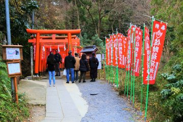 The torii gates and red banners at the shrine entrance