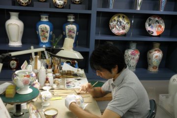 Artists painstakingly hand paint the fine china at Noritake