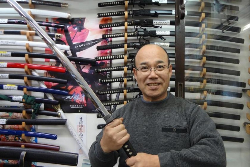 Sankai-do's owner, Kamegaya-san, holding a Samurai sword.