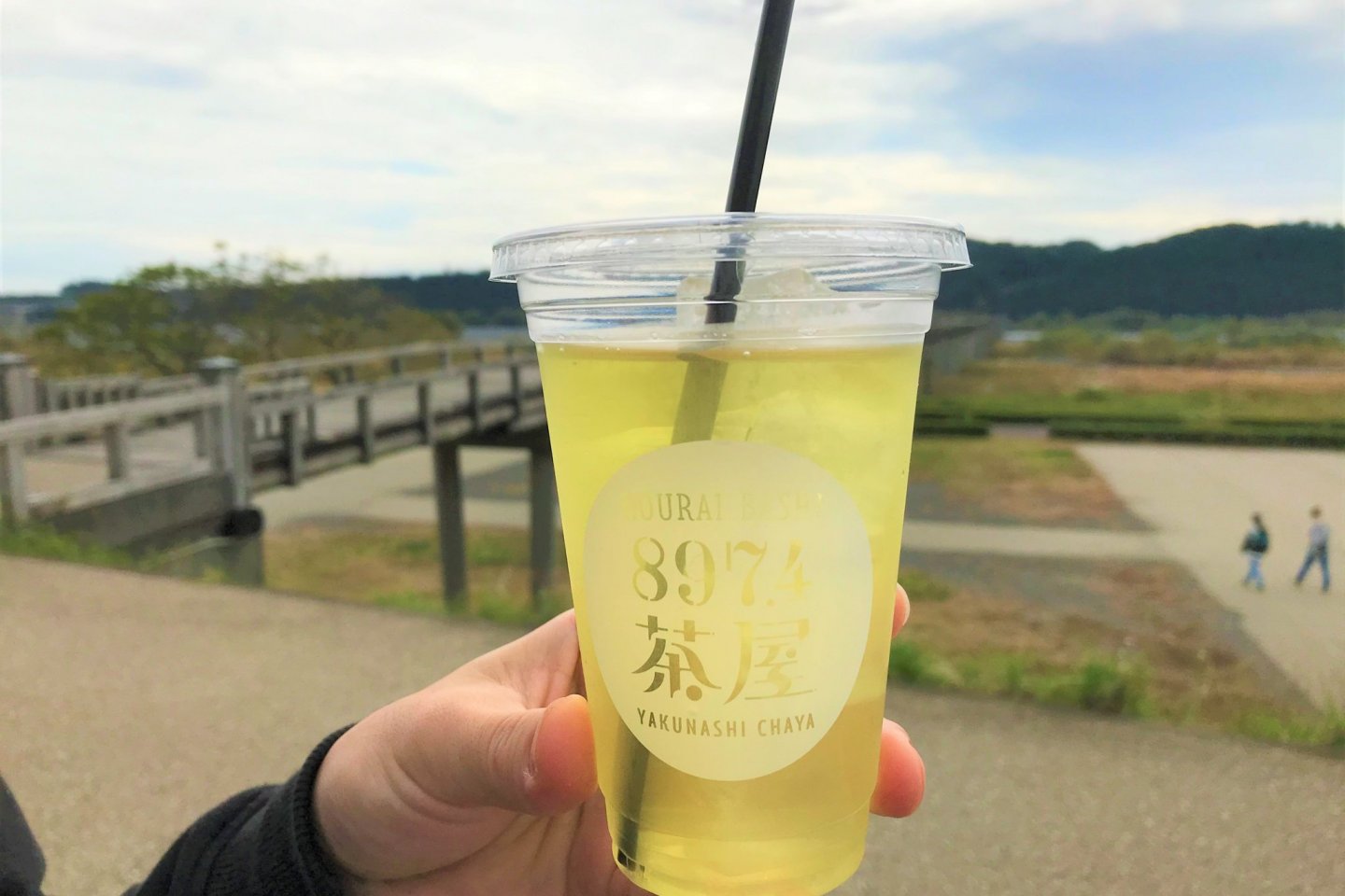Enjoying a refreshing iced green tea alongside the Horai Bridge!