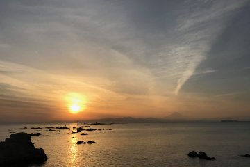 Sunset from Morito Shrine. You can see the torii on tiny Najima Island with the lighthouse near it. Enoshima on the right and a silhouette of Mt. Fuji in the background