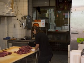 Everything is fresh; Here a woman prepares some meat to go on sale at Kuramon Ichiba Markets
