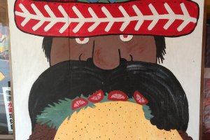 This sign invites passers by to come in to try the jumbo taco, which absolutely does NOT come with moustache hair in it