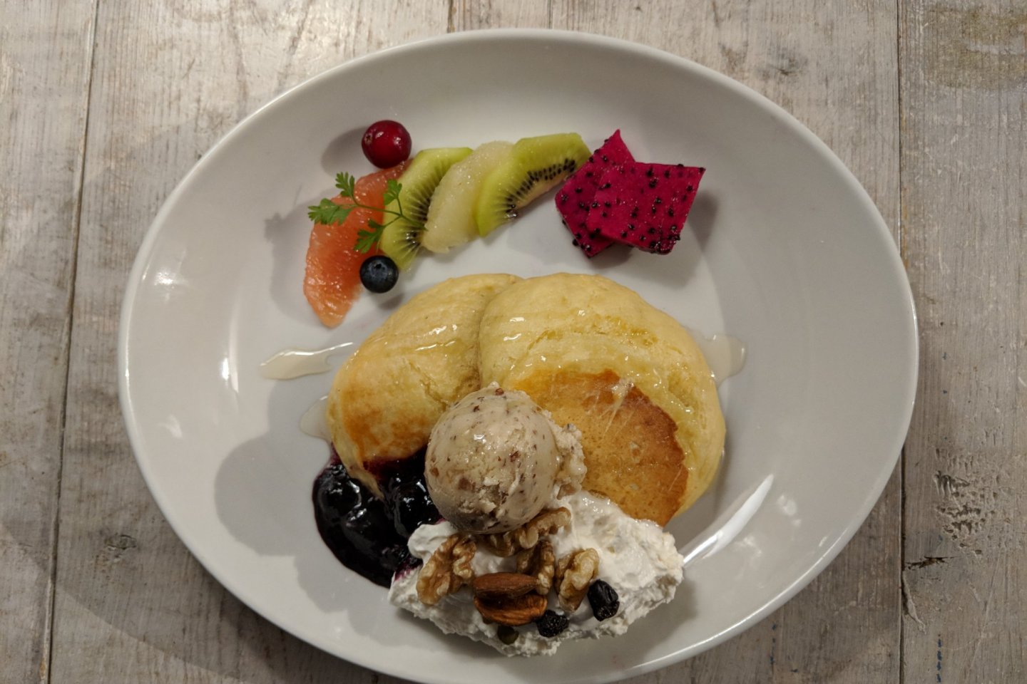 Fluffy, soufflé-style pancakes with soy whipped cream, soy ice cream, fruits and nuts