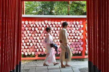 The shrine has heart shaped ema, plus rows of torii arches