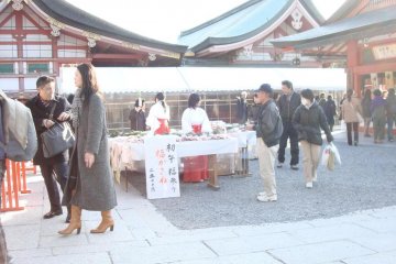 Shrine maidens selling festival items.