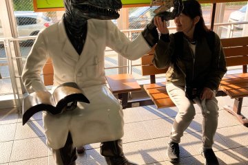  Miwa sitting with a Dinosaur at Fukui Station