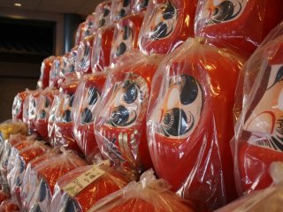 You'll see towers of Daruma dolls as you enter the factory
