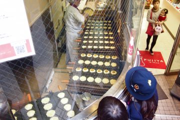 School children looking at the process of baking Pekko-chan Yaki.