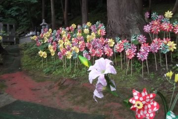<p>Pinwheels in the trees beside the approach to the Daibutsu</p>