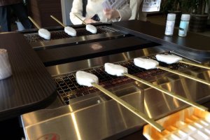 Grilling our own kamaboko at the factory store.