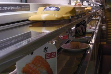 Yellow shinkansen delivering a custom order to the table