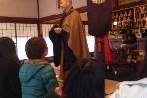 A priest discusses the finer points of Zen Buddhism before a group mediation session.