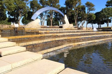 <p>A miniature Peace Arch situated on top of the fountain stairway at Mikasa Park</p>