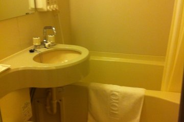 Bathroom with washlet and combined shower bath