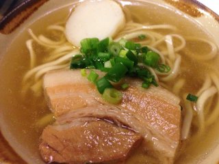 A small order of Okinawa Soba shown here comes with a slice of fish cake, a slice of three-stripe pork and green onions