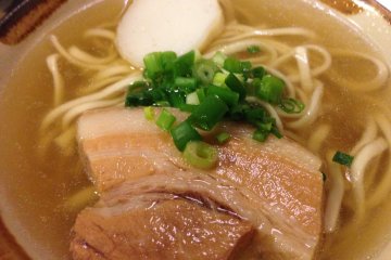 <p>A small order of Okinawa Soba shown here comes with a slice of fish cake, a slice of three-stripe pork and green onions</p>