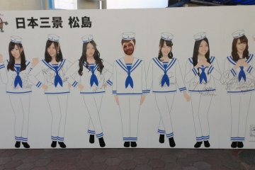 <p>Some AKB48 members (a&nbsp;popular all girls singing group) can be found around Matsushima on flyers and posters to boost tourism. But wait! One of these girls is different than the others.</p>