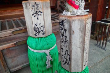 <p>Huge wooden blocks hanging on the bell ropes in front of the Main Temple</p>