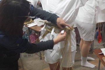 <p>Putting on the traditional clothes is harder than it looks and often requires assistance.</p>
