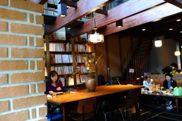 <p>Books lining&nbsp;the wall of the cafe</p>