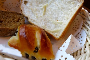 <p>Chocolate chip roll, fresh slice of white bread and fennel bread</p>
